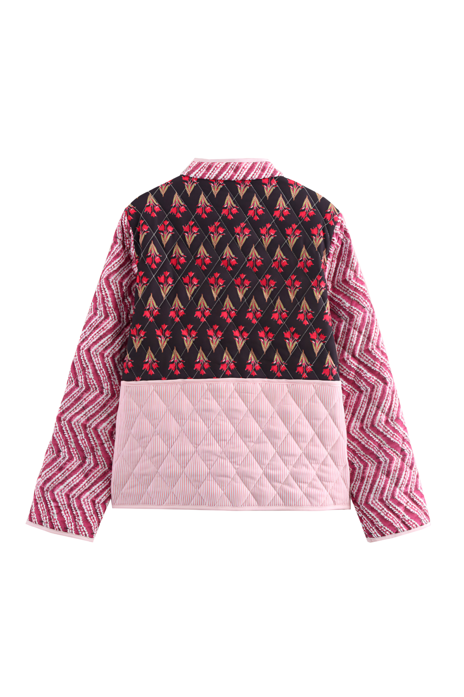 Woman wearing a quilted patchwork jacket featuring mixed floral and chevron prints, paired with a white maxi skirt.
