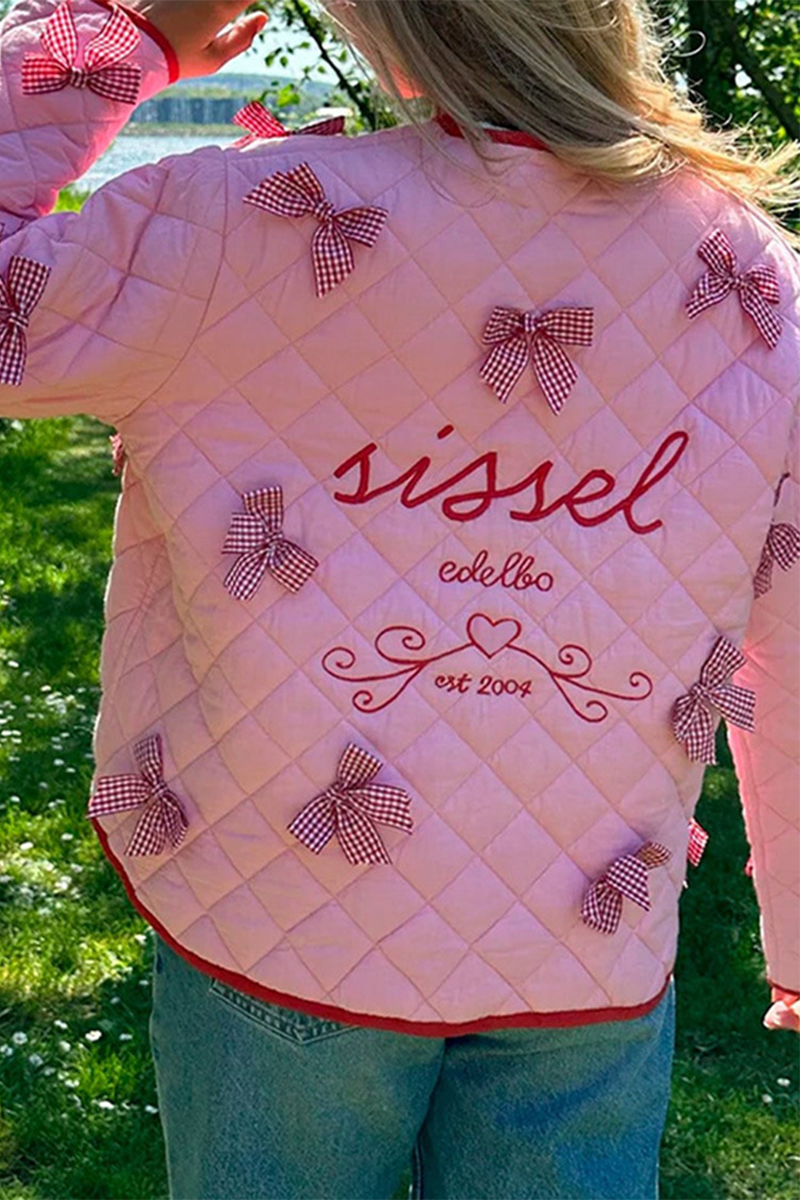 Pink - Women's pink diamond-quilted jacket featuring red contrast trim, red tie-front closures, and decorative red and white gingham bows.
