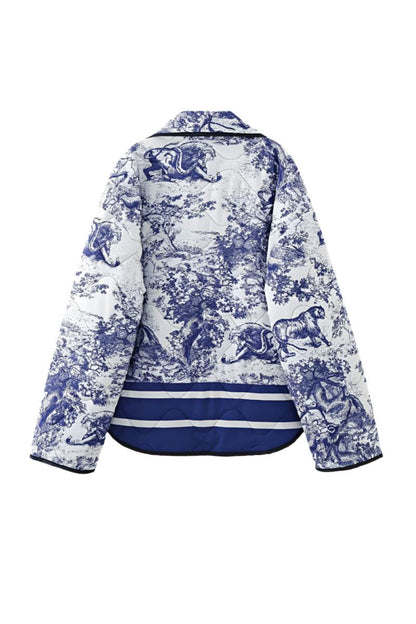 Women's oversized quilted jacket featuring a navy and white toile scenic print, open front, and contrast striped borders on the wide sleeves and hem.