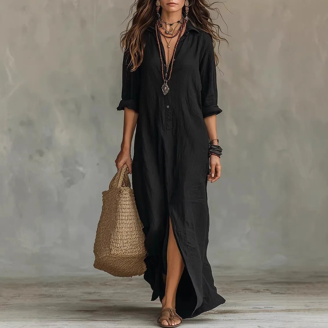 Black - A woman wearing a relaxed-fit white linen maxi sundress with a pointed collar, button placket, and front slit, carrying a woven straw bag.