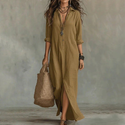 Khaki - A woman wearing a relaxed-fit white linen maxi sundress with a pointed collar, button placket, and front slit, carrying a woven straw bag.