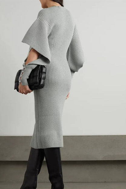 Grey - Model wearing a ribbed knit V-neck midi dress featuring dramatic split flared sleeves and a fitted silhouette.
