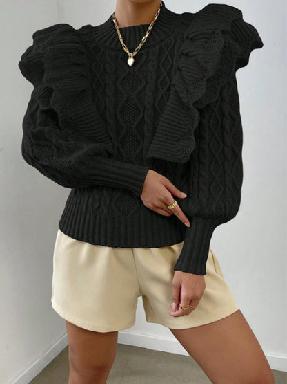 Black - Women's cream chunky cable knit sweater featuring dramatic oversized ruffles on the shoulders and a ribbed crew neckline, styled with beige shorts and a brown belt.