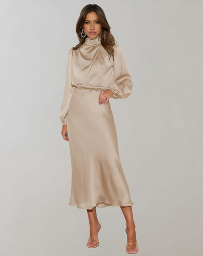 Beige - Woman wearing a long sleeve satin midi dress with a high gathered neckline and cinched waist