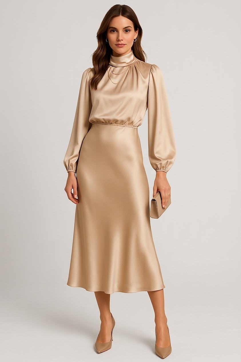Beige - A woman wearing a champagne-coloured satin midi dress with a high neckline, long balloon sleeves, and an elasticated waist, posing against a neutral grey background.
