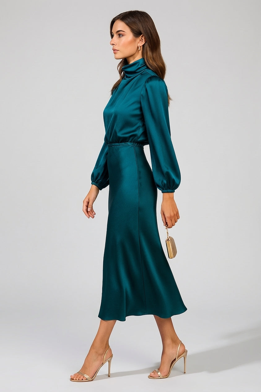 Black - A woman wearing a champagne-coloured satin midi dress with a high neckline, long balloon sleeves, and an elasticated waist, posing against a neutral grey background.
