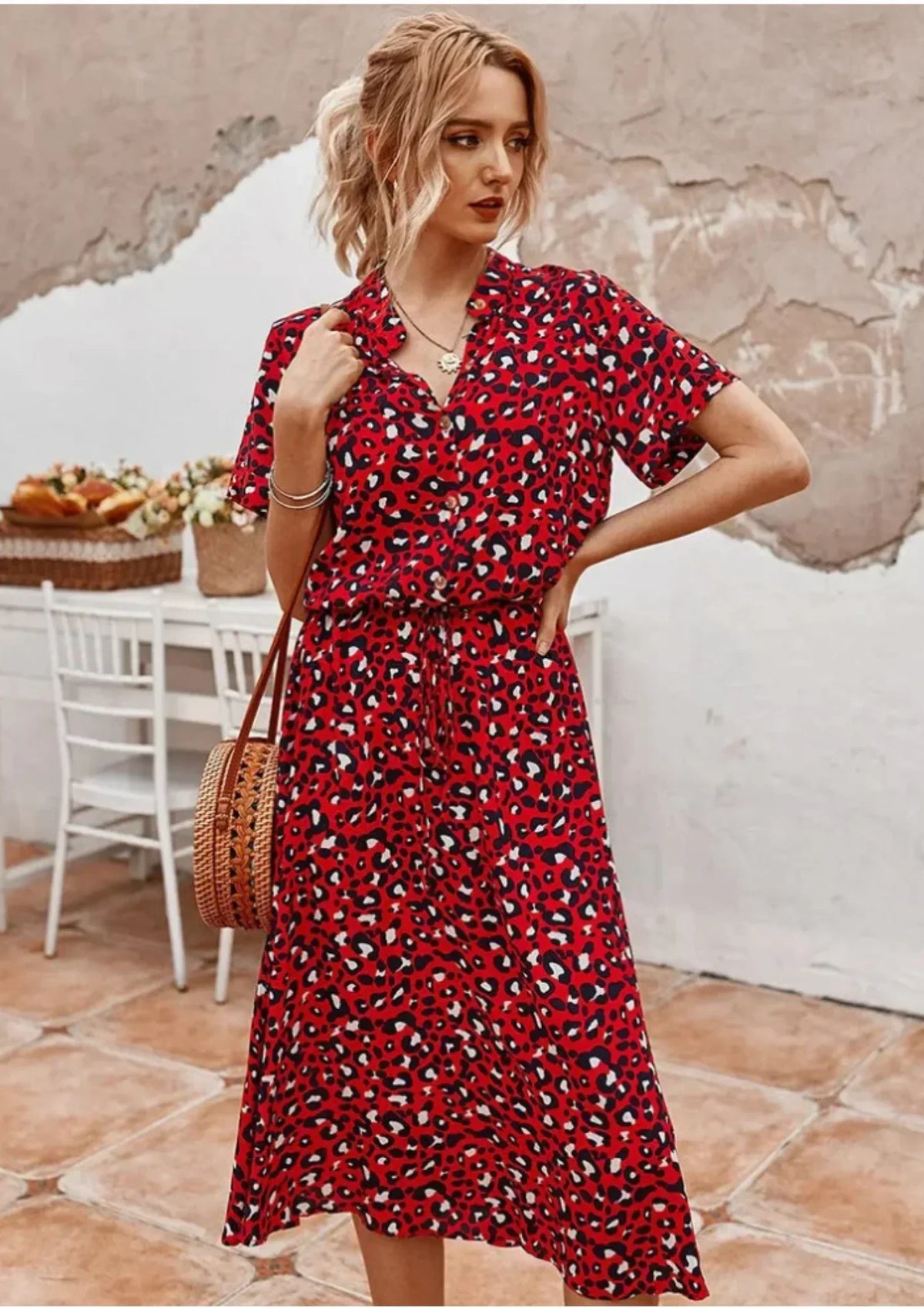 Red - Woman wearing a white midi shirt dress with a brown abstract spotted print, featuring a collared button-front bodice and a drawstring waist.