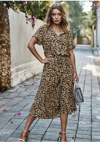 Khaki - Woman wearing a white midi shirt dress with a brown abstract spotted print, featuring a collared button-front bodice and a drawstring waist.