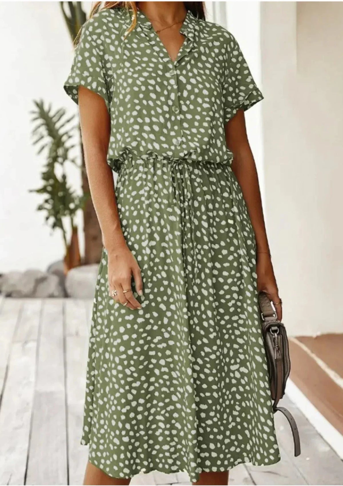 Khaki - Woman wearing a white midi shirt dress with a brown abstract spotted print, featuring a collared button-front bodice and a drawstring waist.