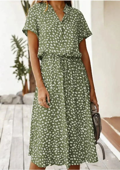 Khaki - Woman wearing a white midi shirt dress with a brown abstract spotted print, featuring a collared button-front bodice and a drawstring waist.