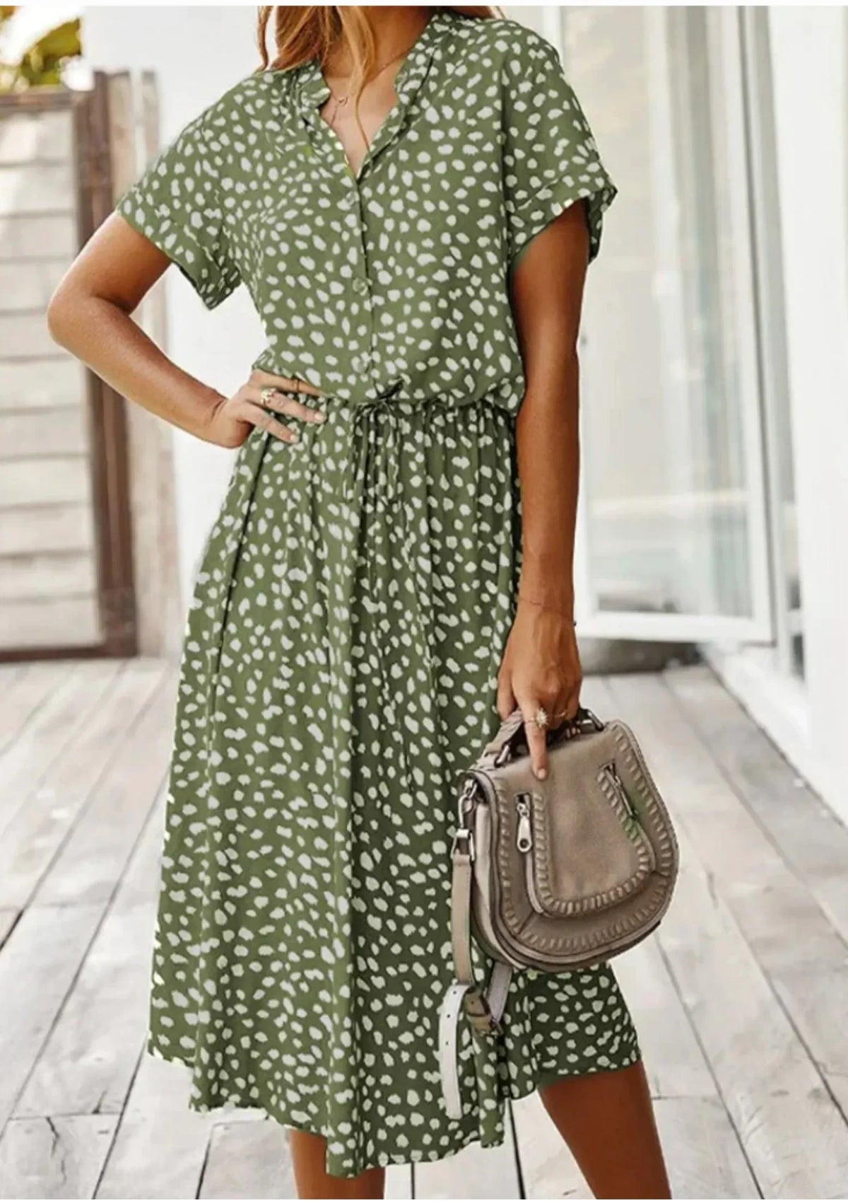 Green - Woman wearing a white midi shirt dress with a brown abstract spotted print, featuring a collared button-front bodice and a drawstring waist.