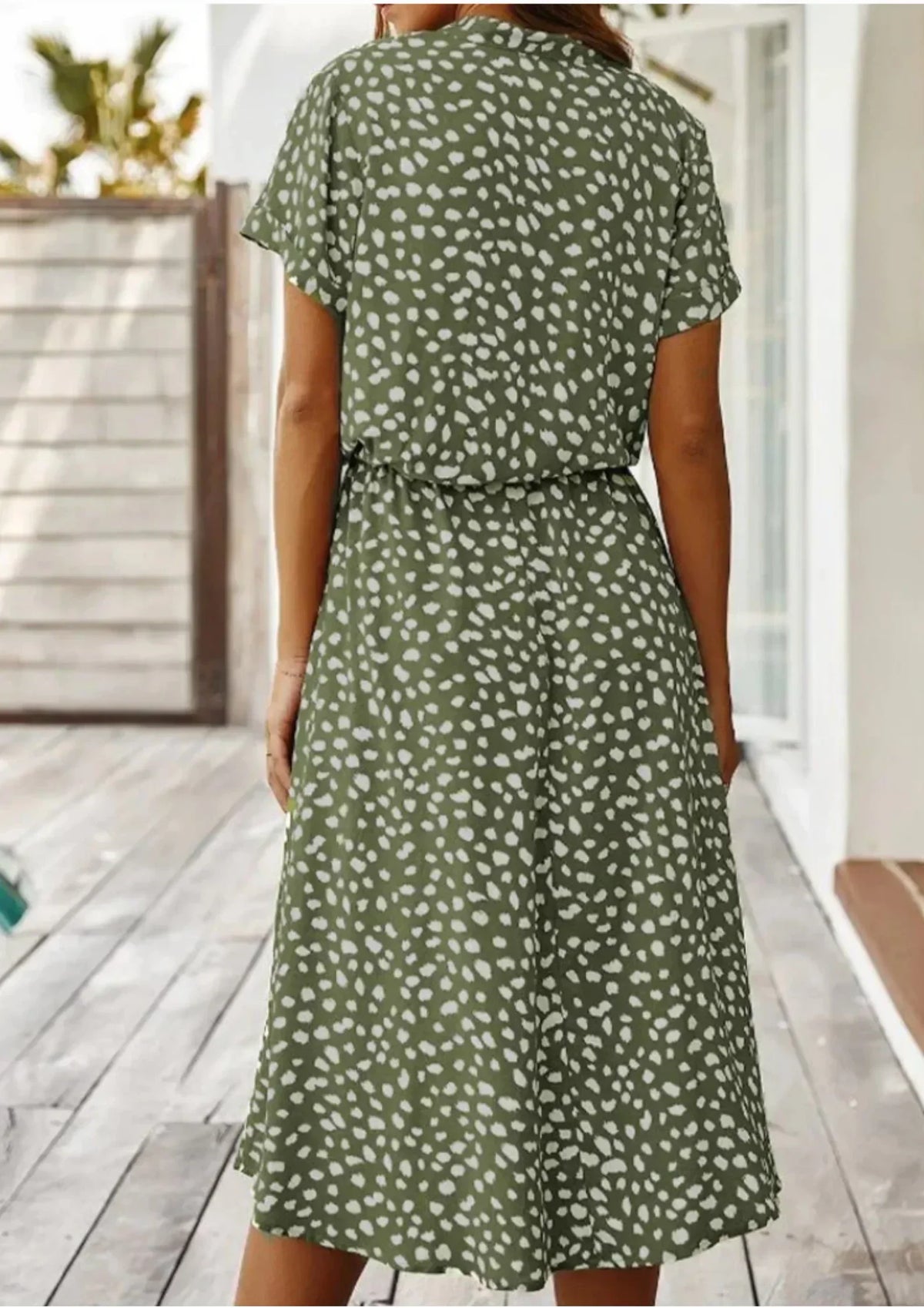 Green - Woman wearing a white midi shirt dress with a brown abstract spotted print, featuring a collared button-front bodice and a drawstring waist.
