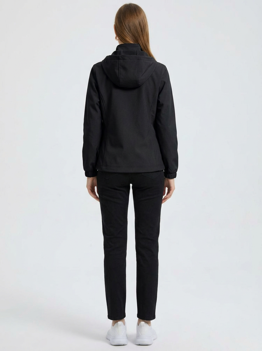 Black - A woman wearing a cream-coloured structured hooded jacket with a contrast black front zipper, elasticised cuffs, and side pockets, paired with black pants.