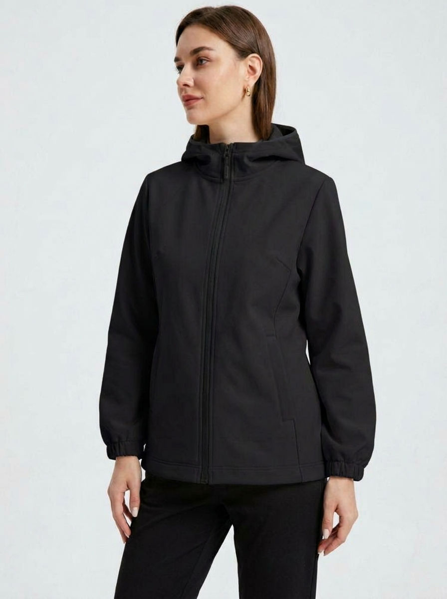 Black - A woman wearing a cream-coloured structured hooded jacket with a contrast black front zipper, elasticised cuffs, and side pockets, paired with black pants.