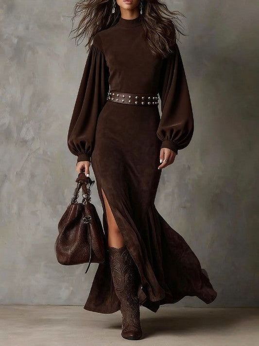 UK 18 (2XL) - Woman modelling a heavyweight suede maxi dress featuring long puff sleeves and a high side slit.