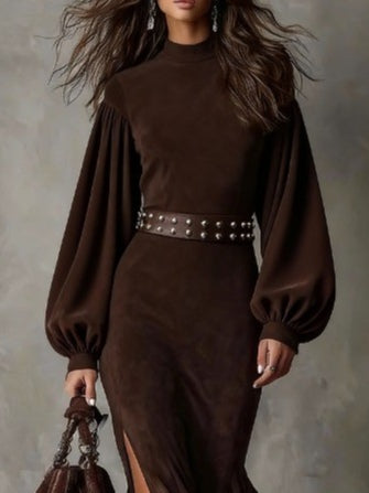 UK 18 (2XL) - Woman modelling a heavyweight suede maxi dress featuring long puff sleeves and a high side slit.