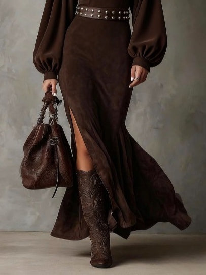 UK 18 (2XL) - Woman modelling a heavyweight suede maxi dress featuring long puff sleeves and a high side slit.