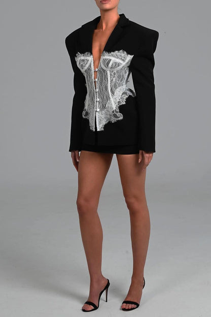 Black - Tailored long-sleeve mini blazer dress featuring strong shoulders, notched lapels, and a prominent sheer lace corset overlay with center button detailing