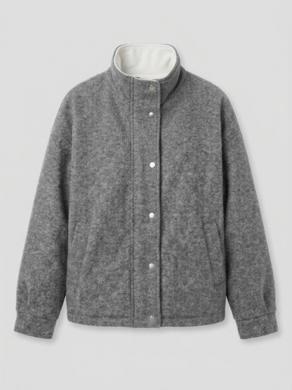 Gray - A woman wearing a dark navy blue textured jacket with a high stand collar lined in contrast cream fleece, featuring a snap-button front closure and a relaxed fit.