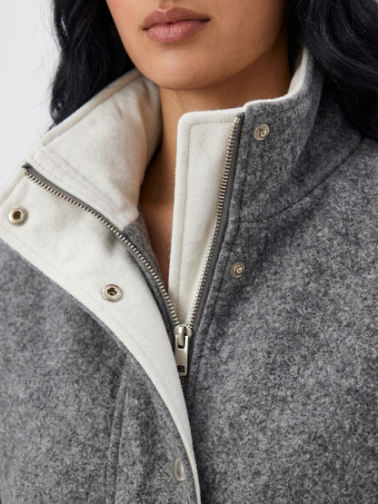 Gray - A woman wearing a dark navy blue textured jacket with a high stand collar lined in contrast cream fleece, featuring a snap-button front closure and a relaxed fit.