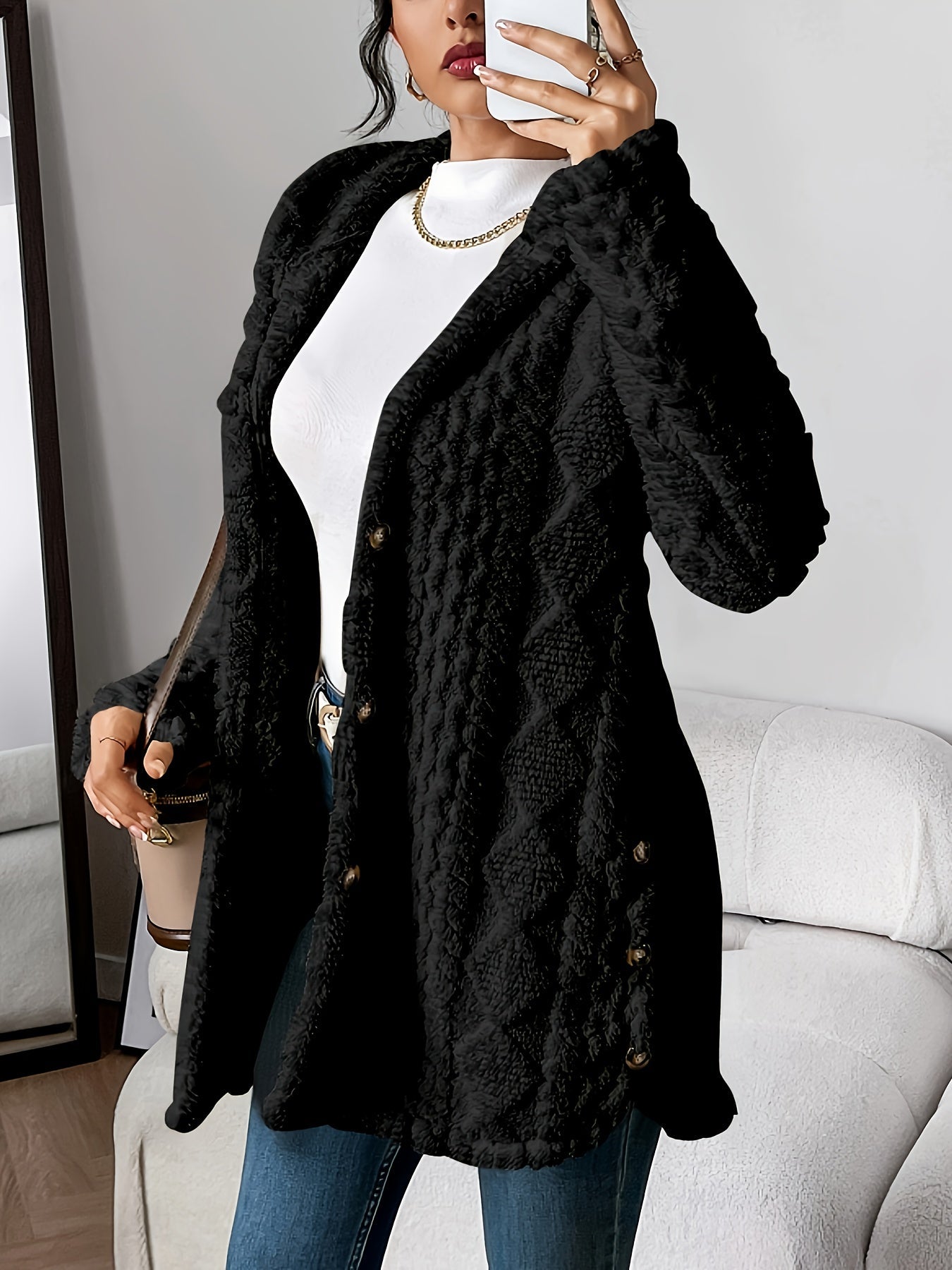Khaki - A woman wearing a beige, mid-length textured fleece hooded jacket with a diamond pattern, button closure, and buttoned side vents, layered over a white high-neck top and blue jeans.
