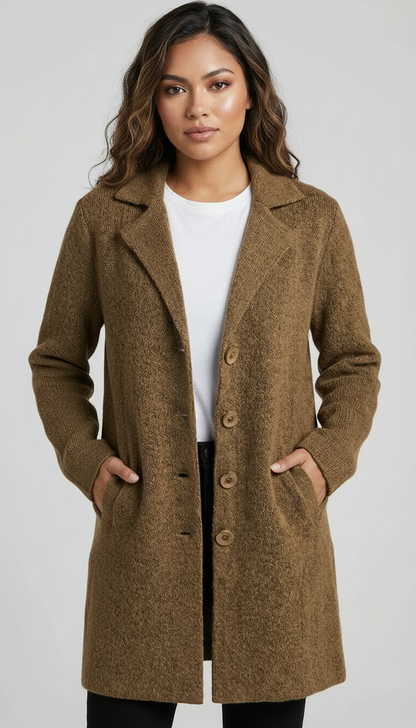 Red - A woman wearing a textured green mid-length coat with a notch lapel, single-breasted buttons, and cuffed sleeves, styled over a white top and dark grey jeans.