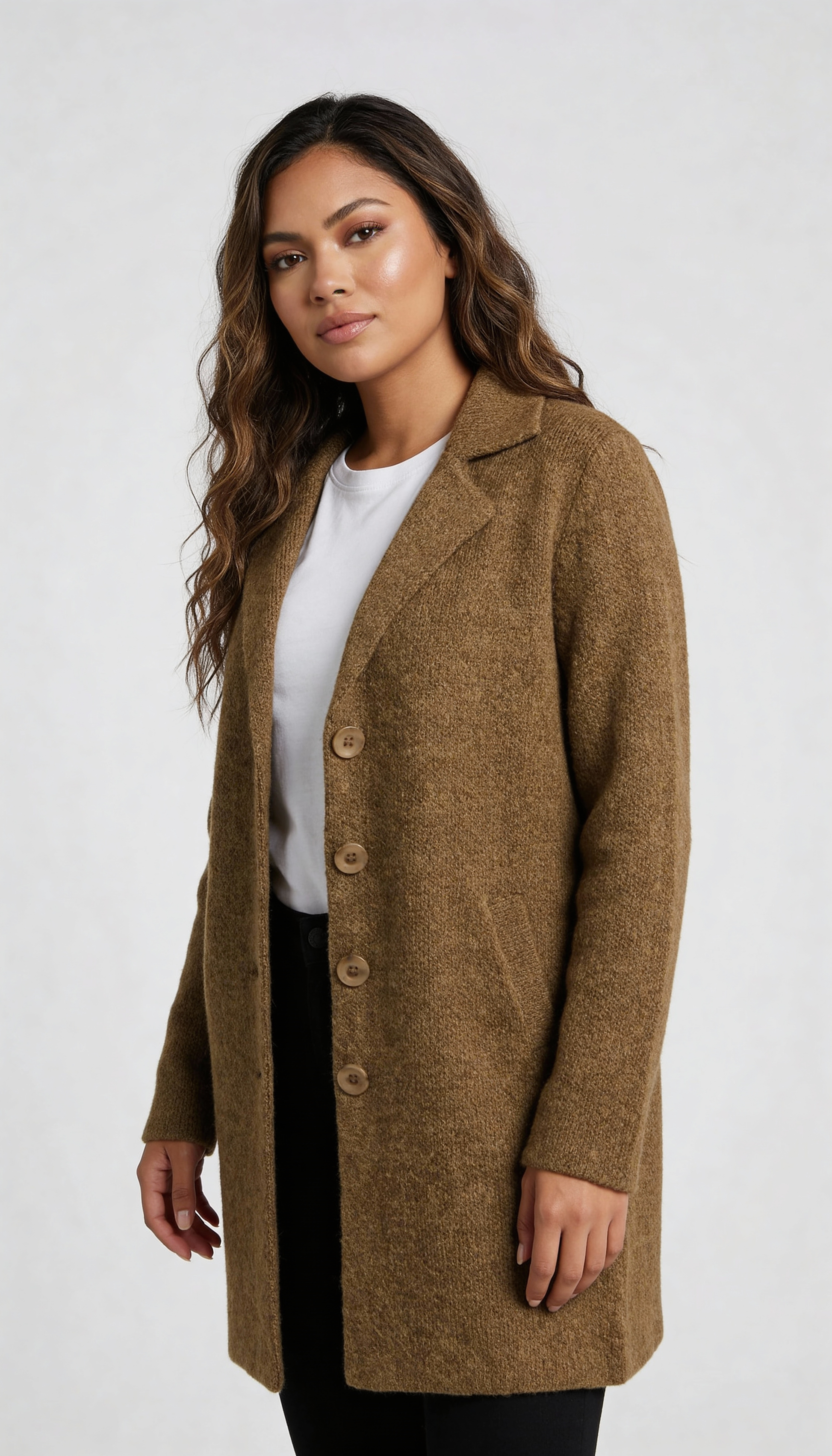 Red - A woman wearing a textured green mid-length coat with a notch lapel, single-breasted buttons, and cuffed sleeves, styled over a white top and dark grey jeans.