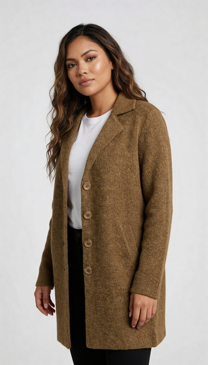 Red - A woman wearing a textured green mid-length coat with a notch lapel, single-breasted buttons, and cuffed sleeves, styled over a white top and dark grey jeans.