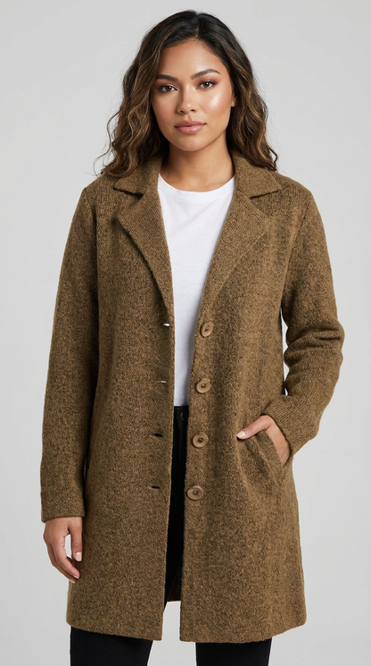 Brown - A woman wearing a textured green mid-length coat with a notch lapel, single-breasted buttons, and cuffed sleeves, styled over a white top and dark grey jeans.