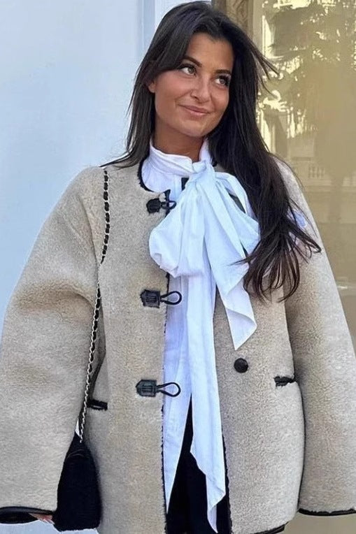 Khaki - Women's heavyweight cream faux shearling jacket featuring a collarless neckline, black toggle closures, contrast black piping, and an oversized fit.