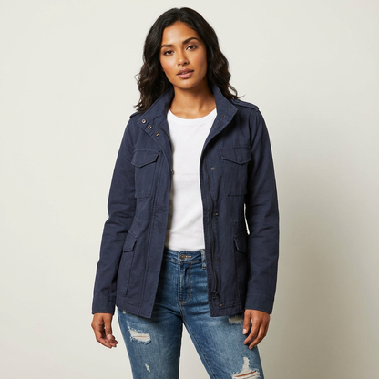 Blue - A woman wearing a structured olive green twill utility jacket with four front flap pockets, a funnel neck, and a zip-front closure, styled over a white t-shirt and blue jeans.