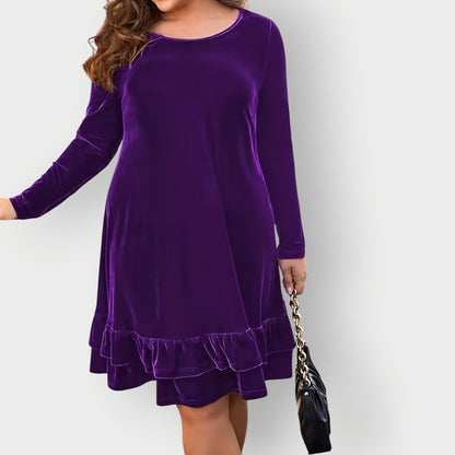 Violet - Woman wearing a solid long sleeve velvet A-line dress featuring a double tiered ruffle hem