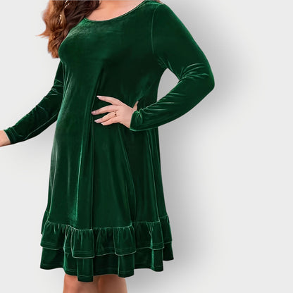 Green - Woman wearing a solid long sleeve velvet A-line dress featuring a double tiered ruffle hem