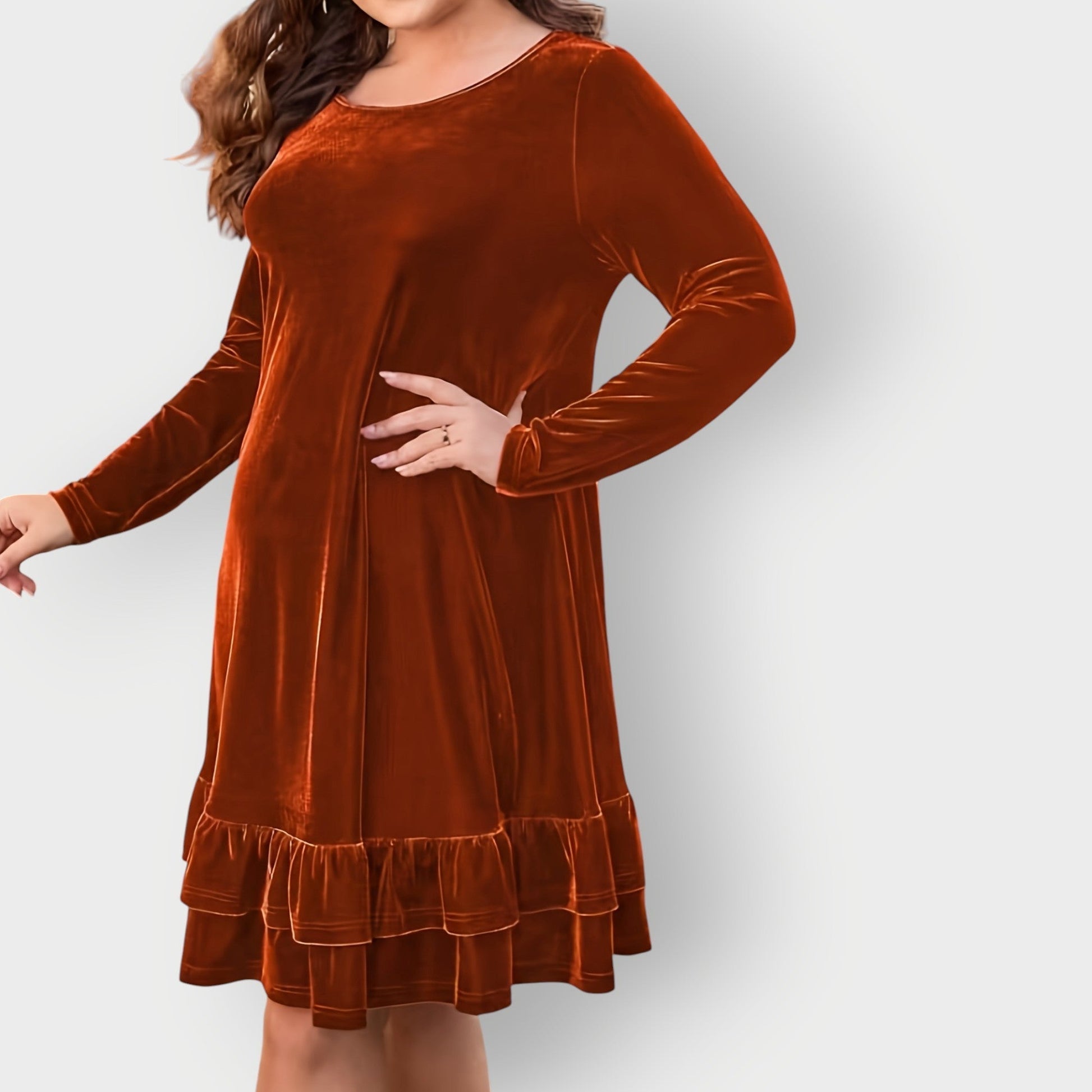 Bronze - Woman wearing a solid long sleeve velvet A-line dress featuring a double tiered ruffle hem