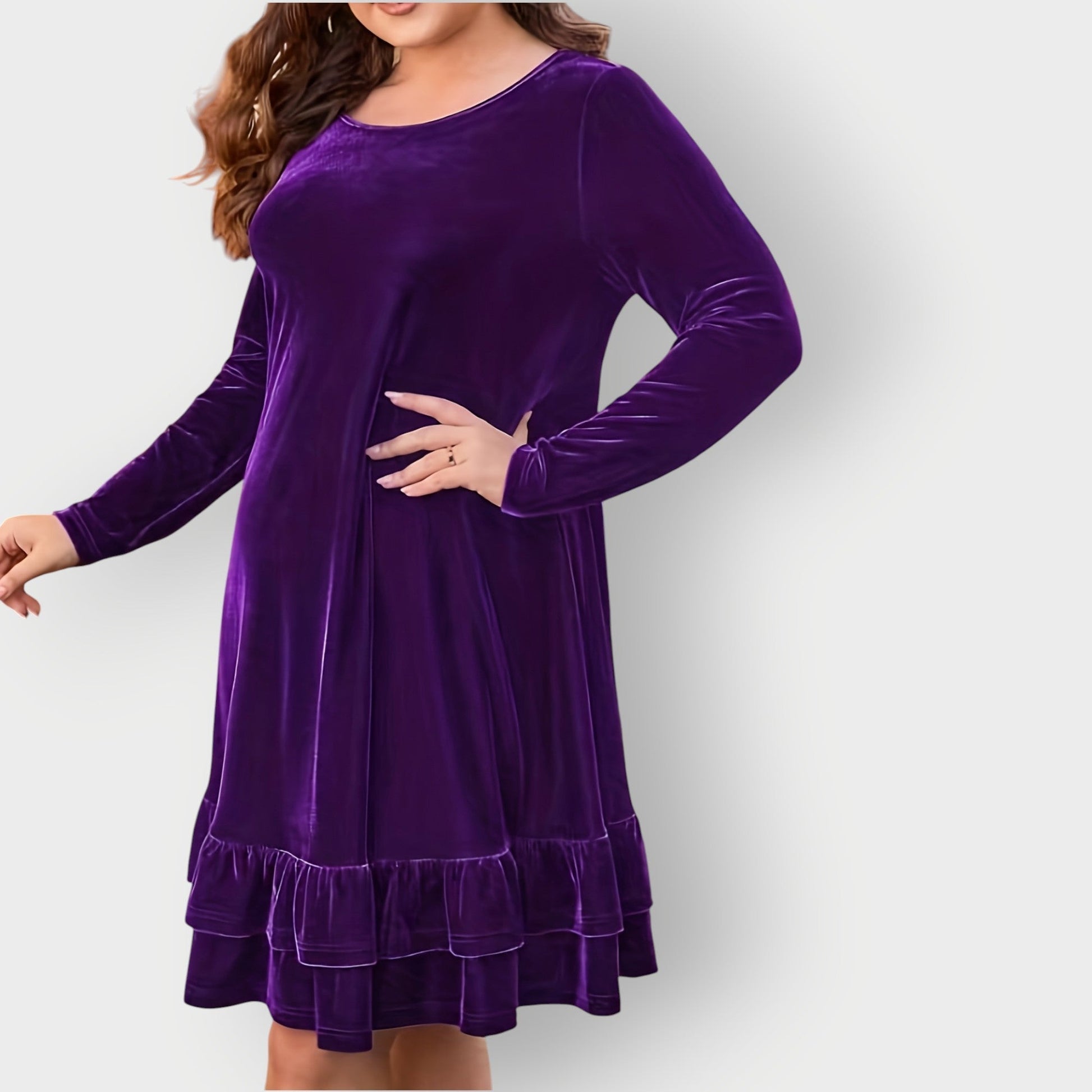 Violet - Woman wearing a solid long sleeve velvet A-line dress featuring a double tiered ruffle hem