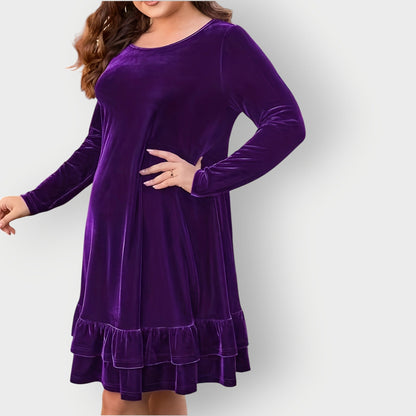 Violet - Woman wearing a solid long sleeve velvet A-line dress featuring a double tiered ruffle hem