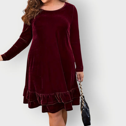 Violet - Woman wearing a solid long sleeve velvet A-line dress featuring a double tiered ruffle hem