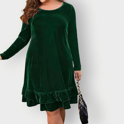 Violet - Woman wearing a solid long sleeve velvet A-line dress featuring a double tiered ruffle hem