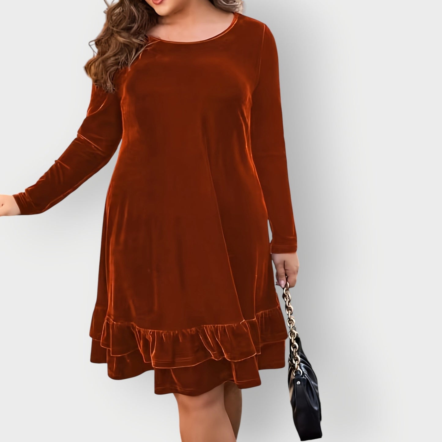 Violet - Woman wearing a solid long sleeve velvet A-line dress featuring a double tiered ruffle hem