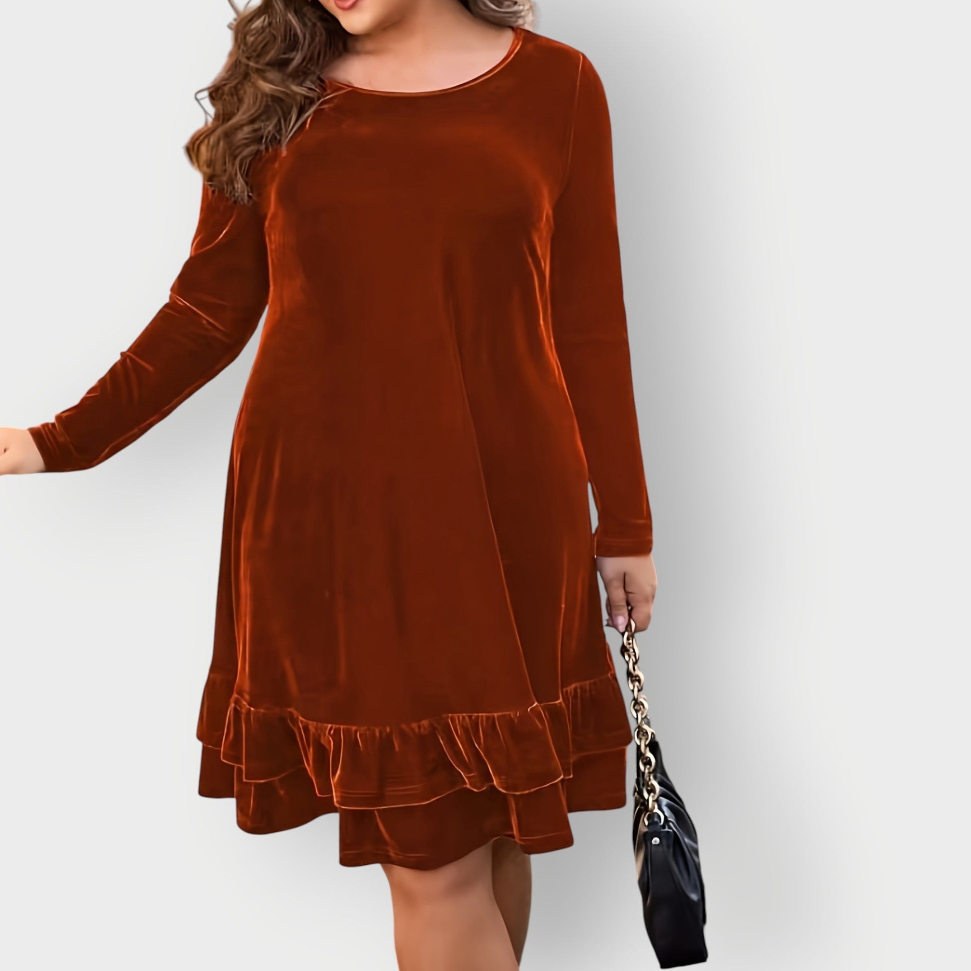 Violet - Woman wearing a solid long sleeve velvet A-line dress featuring a double tiered ruffle hem