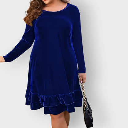 Violet - Woman wearing a solid long sleeve velvet A-line dress featuring a double tiered ruffle hem