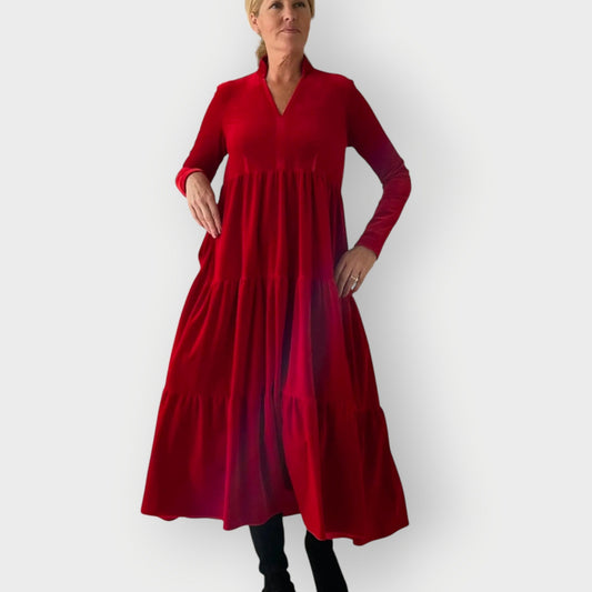Red - Woman wearing a solid colour velvet long sleeve tiered maxi dress with a stand collar