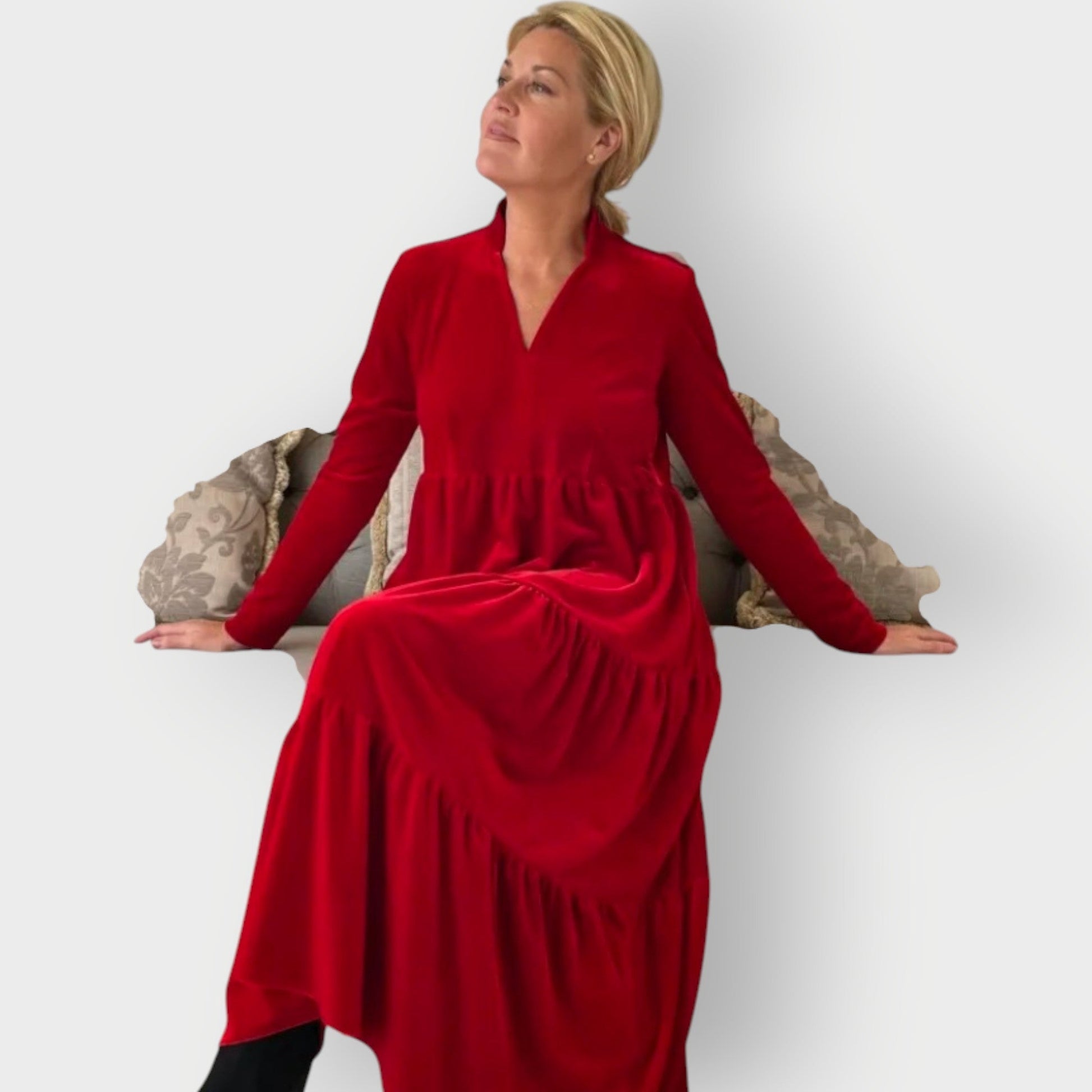 Red - Woman wearing a solid colour velvet long sleeve tiered maxi dress with a stand collar