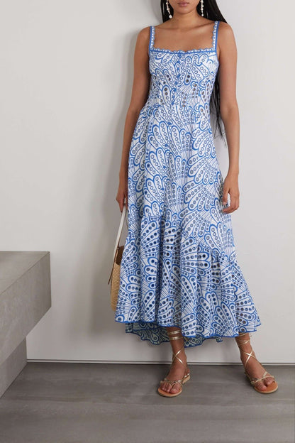 Woman in blue and white embroidered cotton maxi dress