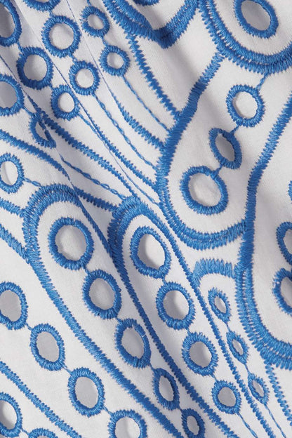 Woman in blue and white embroidered cotton maxi dress