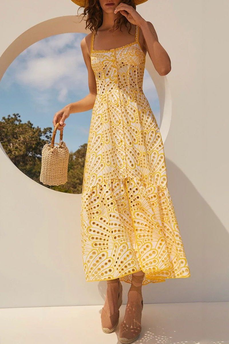 Woman in blue and white embroidered cotton maxi dress