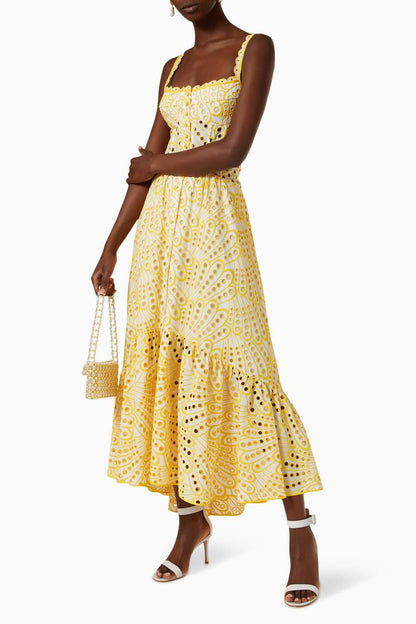 Woman in blue and white embroidered cotton maxi dress