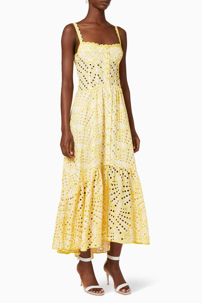 Woman in blue and white embroidered cotton maxi dress
