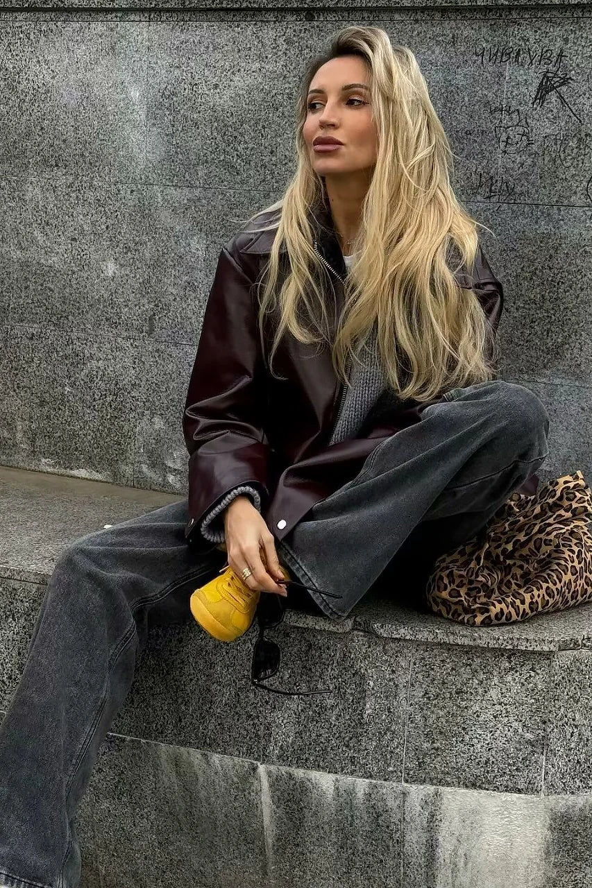 Amaranth - Women's deep burgundy faux leather zip-front cropped bomber jacket with a wide collar, styled over a black top and dark denim.