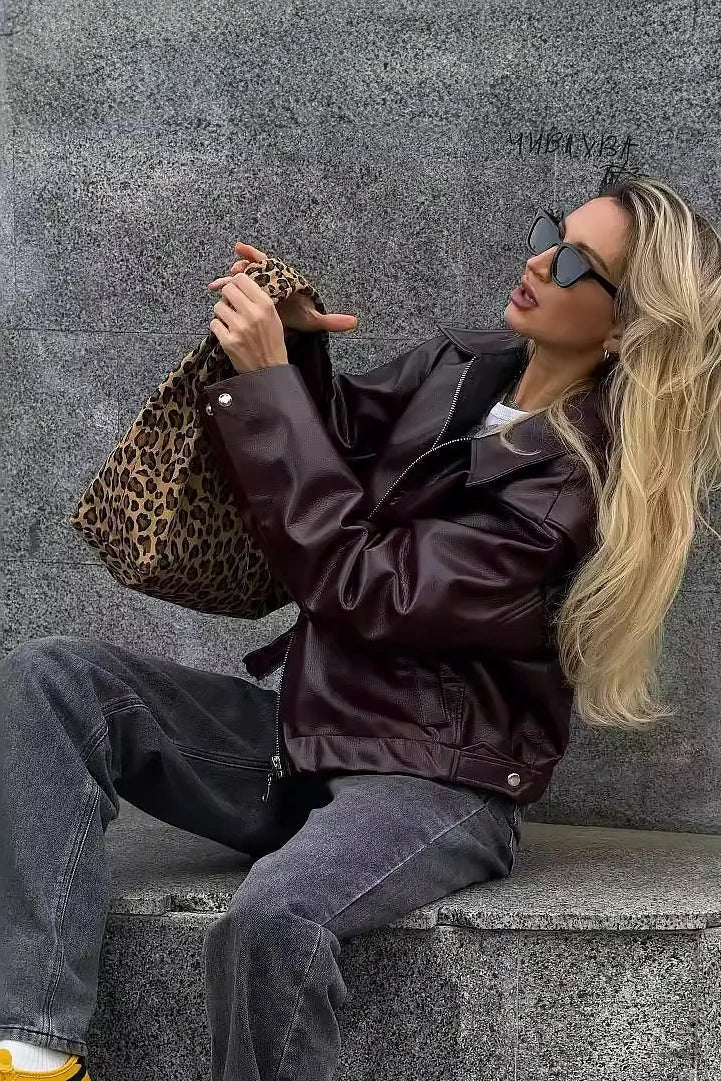 Amaranth - Women's deep burgundy faux leather zip-front cropped bomber jacket with a wide collar, styled over a black top and dark denim.